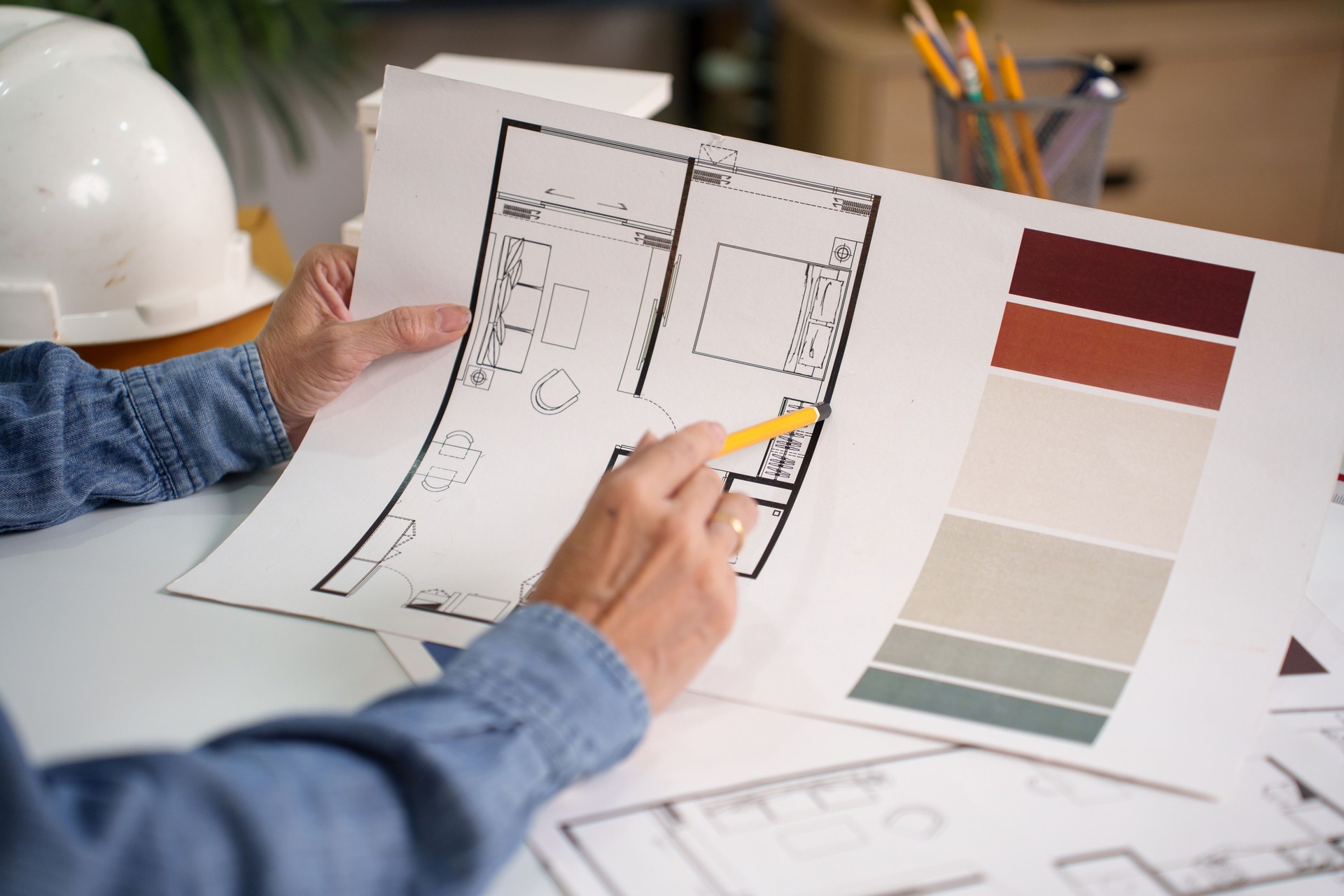 Architect Hands Examining Blueprint with Color Palette for Interior Design Renovation Project Architect Plans Review and Home Design Projects with Blueprints